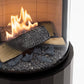 Cozo FLOGS – fire chamber close-up: flames around the ceramic logs and glass gravel behind the curved glass