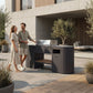 Couple by the OVO GL outdoor kitchen in a modern backyard